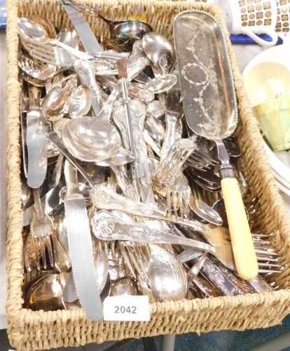 A quantity of plated ware, consisting of knives, forks, spoons, tea strainer, etc. (1 basket)