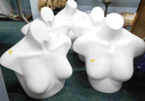 Five female plastic shop dummy display torsos.