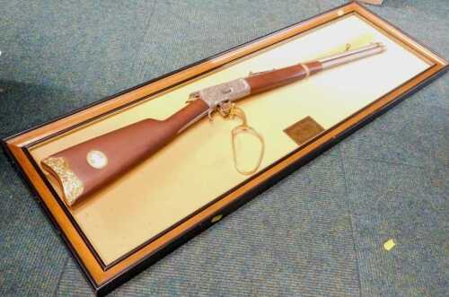John Wayne Collection 1892 model .44-40 Winchester rifle, on display board, with bullet case gun...