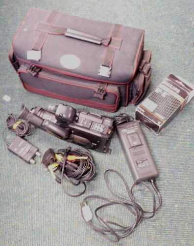 Camera equipment, consisting of a Panasonic G202 VHSC video camera, in a canvas Jumbo camera bag.