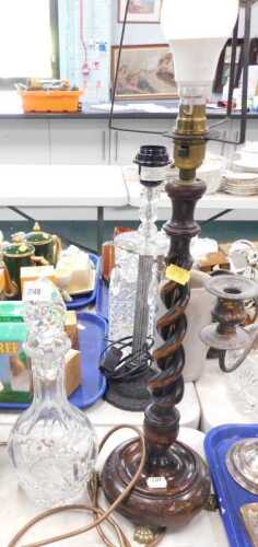 A cut glass decanter, together with a carved barley twist wooden standard lamp, with brass lion...