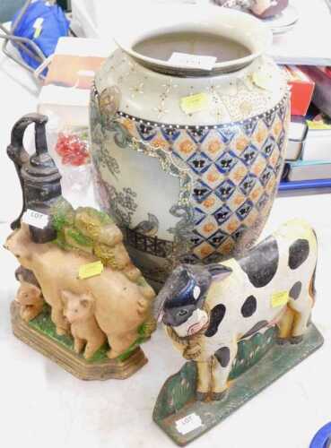 A cast iron doorstop of pig and piglets, together with a cast iron doorstop of a cow, and an...