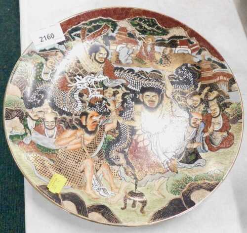 A Japanese Kyoto Choshuzan style Satsuma plate, Meiji type, profusely decorated with figures of...