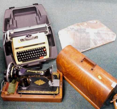 A wooden cased Singer sewing machine, together with a mid 20thC overmantel mirror, and a cased...