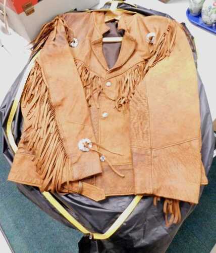 A brown leather cowboy jacket, with tassels and chrome plated buckles and buttons, size Large,...