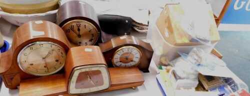 Four mid century wooden mantel clocks, together with various clock spare parts, light switches,...