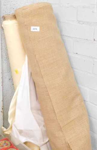 Material, consisting of a roll of hessian, and a roll of cream satin type material.