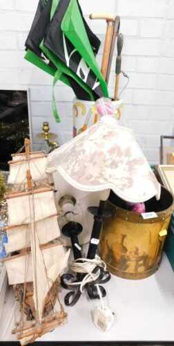 A ceramic umbrella stand, containing walking sticks, umbrellas and parasols, together with a...