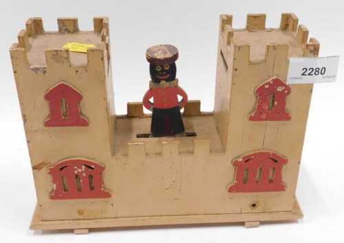 A scratch built novelty money box, in the form of a castle, with central articulated figure.