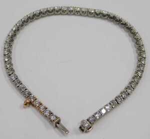 A diamond Protea tennis bracelet, set with forty five round brilliant cut diamonds, totalling... - 2