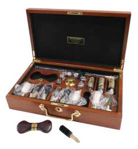 A late 20thC William Powell Gun & Rifle Makers gun cleaning kit, in a mahogany case of...