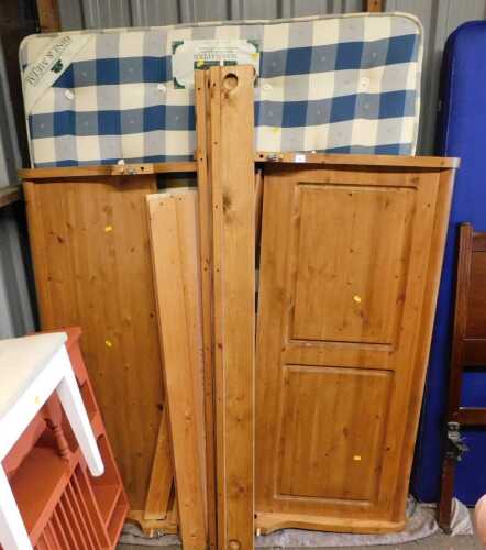 A pine double bed frame, comprising a panelled head and footboard, side rails, and slats,...