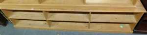 A pine open bookcase, with six sections, raised on a plinth base, 68cm high, 174cm wide, 30cm deep.