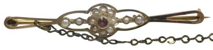 An Edwardian garnet and seed pearl floral bar brooch, in yellow metal, stamped 9c, with a later...