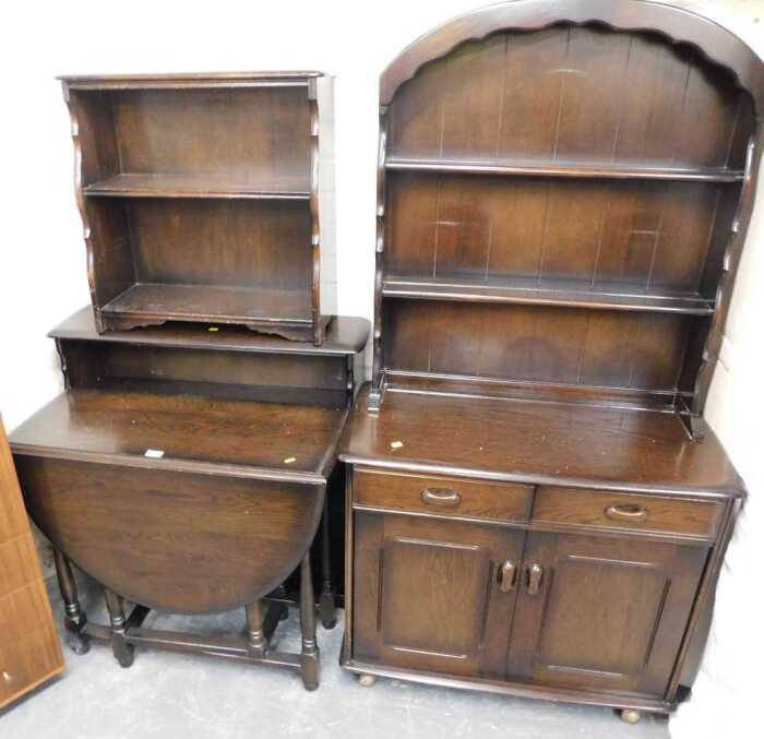 A group of oak furniture, comprising a Welsh dresser, gate leg table, and two open bookcases. (4)