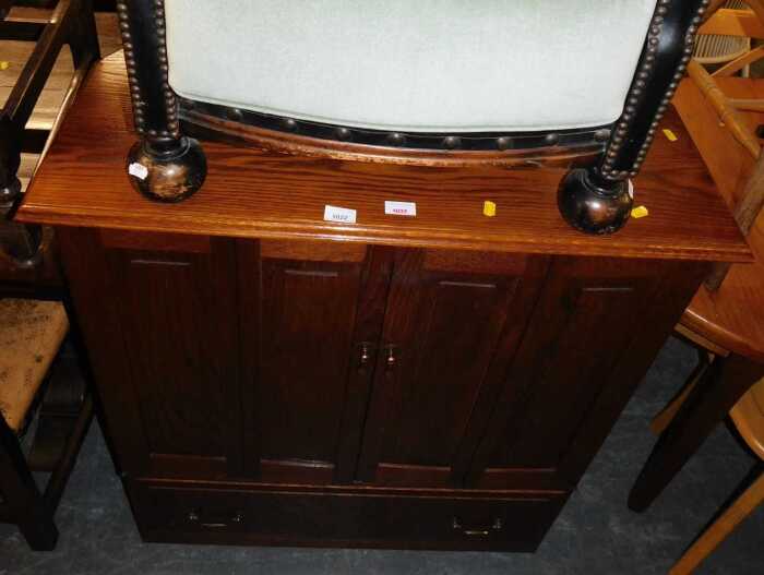 An oak television cabinet, with folding panelled doors and a door to the base, together with a...