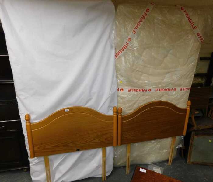 Two single beds, comprising Myers headboards, together with mattresses and single divan bed bases.