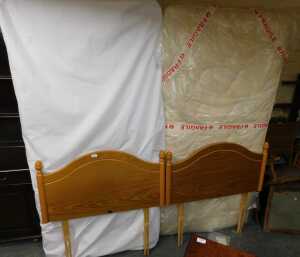 Two single beds, comprising Myers headboards, together with mattresses and single divan bed bases.