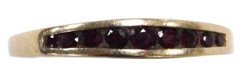 A ruby nine stone ring, the graduated stones in a channel setting, in yellow metal, stamped 9c,...