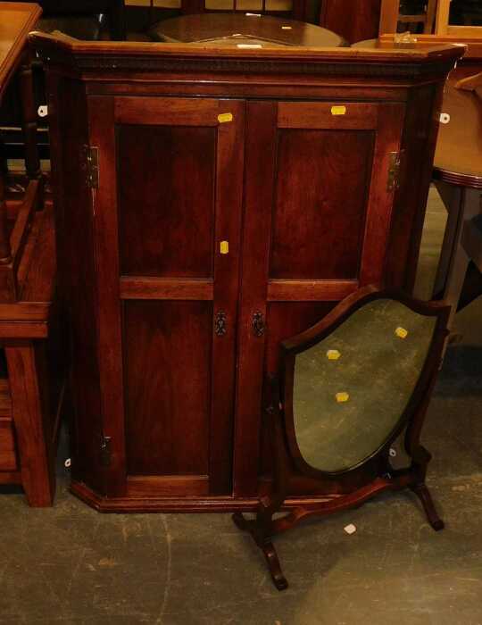 A 19thC mahogany hanging corner cabinet, the top with a dentil moulded cornice, above two...