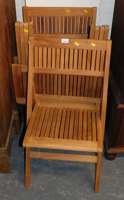 A folding wooden bistro garden table, with slatted top, together with a pair of folding chairs.