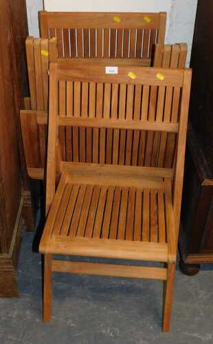 A folding wooden bistro garden table, with slatted top, together with a pair of folding chairs.