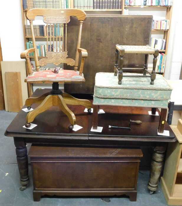 An oak swivel office chair, on castors, together with two stools, a red painted open bookcase,...