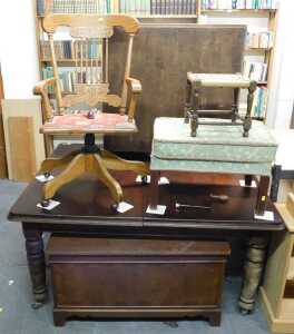 An oak swivel office chair, on castors, together with two stools, a red painted open bookcase,...