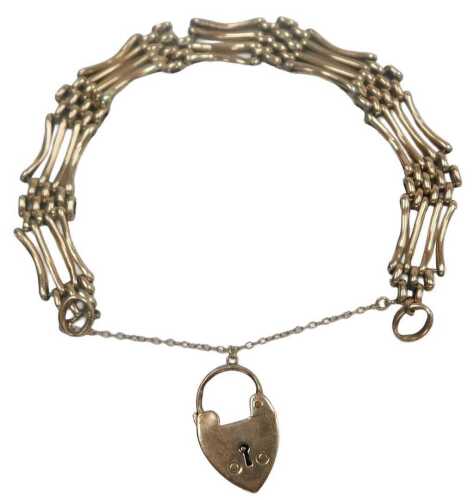 A four bar rose metal gate bracelet, on a heart shaped padlock clasp, with safety as fitted,...