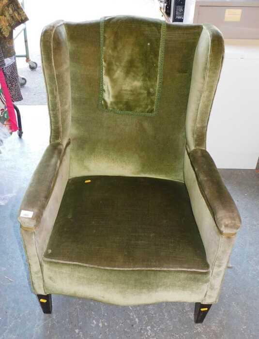 A green draylon upholstered armchair, raised on square tapering legs. JBI to check if fire regs...