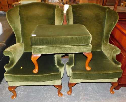 Two Parker Knoll wingback armchairs, upholstered in green draylon, together with a matching...