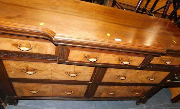A 20thC walnut breakfront sideboard, the base with an arrangement of seven drawers, each with...