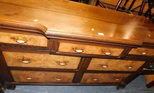 A 20thC walnut breakfront sideboard, the base with an arrangement of seven drawers, each with...