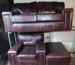 A brown leather sofa suite, comprising a two seater sofa, an armchair, and a footstool. (3)