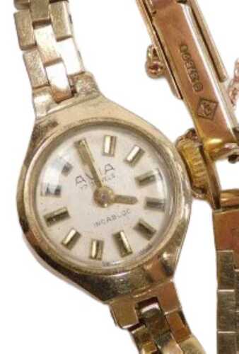 An Avia lady's 9ct gold cased wristwatch, circular champagne dial with baton markers, on a brick...