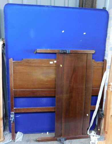 A mahogany double bed, comprising headboard, footboard and bed base.