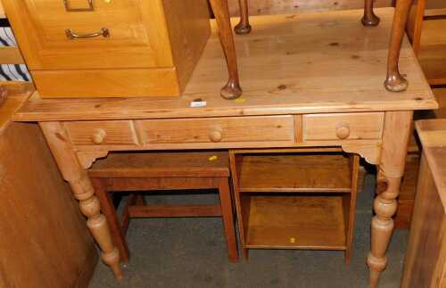 A pine side table, with an arrangement of three drawers, raised on cylindrical turned legs, 76cm...