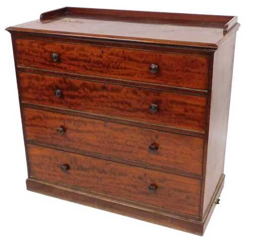 An early Victorian figured mahogany chest of drawers, stamped W&C Wilkinson, 14 Ludgate Hill,...