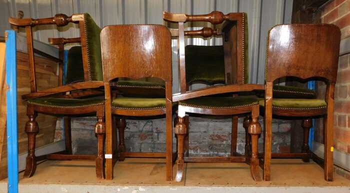 A set of six oak dining chairs, each with a green velour upholstered seat and back.