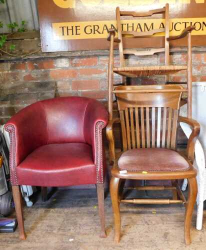 An early 20thC oak chair, together with another with a rush seat, and a red faux leather...