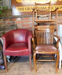 An early 20thC oak chair, together with another with a rush seat, and a red faux leather...