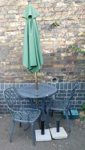 An aluminium garden bistro set, comprising a lattice work table, two chairs, and a parasol.