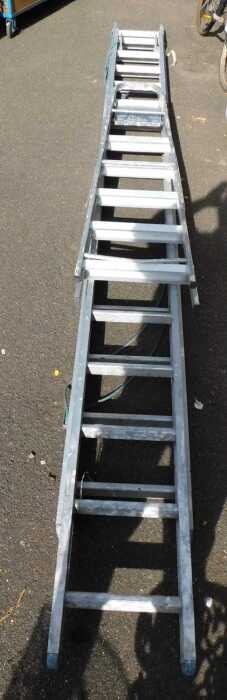 An extending ladder, together with an A frame ladder.