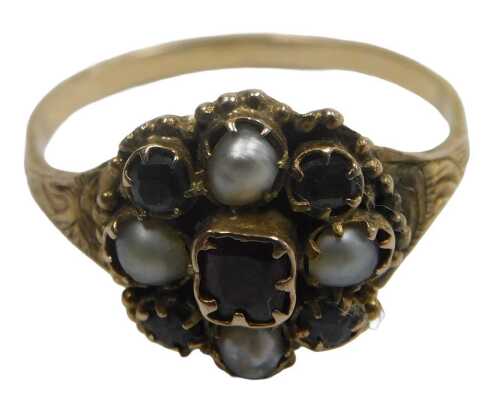 A Victorian garnet seed pearl and demantoid garnet flower head ring, in a Renaissance style...