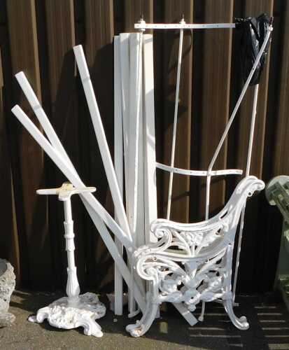 A pair of white painted cast iron bench ends, table base, etc. (a quantity)