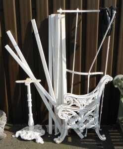 A pair of white painted cast iron bench ends, table base, etc. (a quantity)