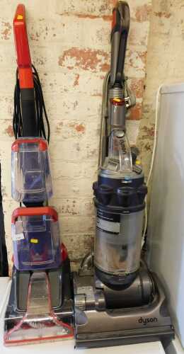 A Bissell carpet cleaner, together with a Dyson upright vacuum cleaner.