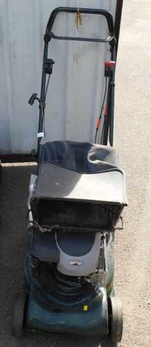 A lawn mower, possibly Hayter, later repainted, with a Briggs and Stratton Harrier 41 engine.