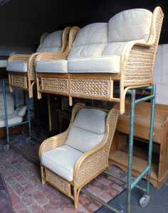 A conservatory bamboo and rattan two seat sofa, and two matching chairs, each with a cream...