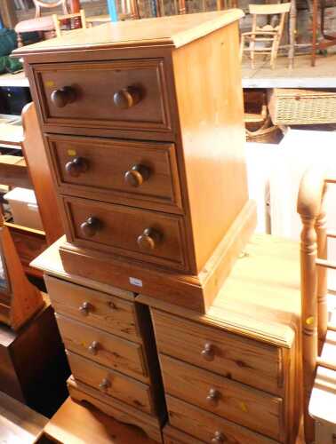 A pair of pine bedside tables, with a moulded top and three drawers below, on bracket feet, and...